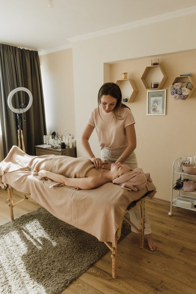 Woman obtaining a gua sha treatment on her body https://karlacorral.com/wp-content/uploads/2023/04/pexels-arina-krasnikova-6663573-1-683x1024.jpg