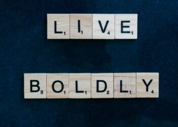 Scrabble tiles forming 'Live Boldly' on a dark blue background for motivation.