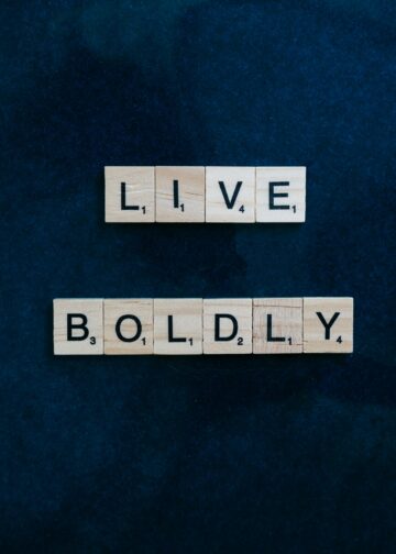 Scrabble tiles forming 'Live Boldly' on a dark blue background for motivation.