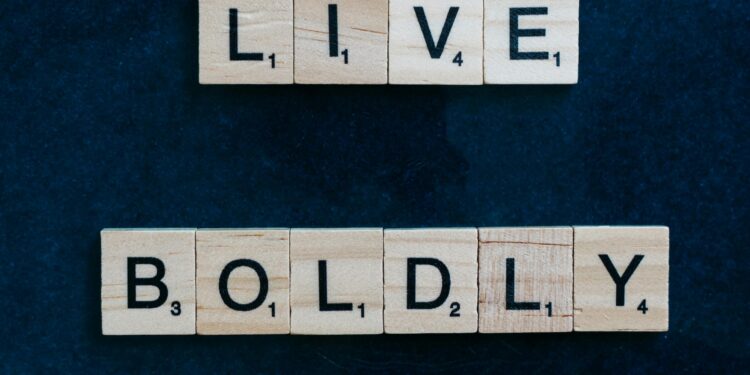Scrabble tiles forming 'Live Boldly' on a dark blue background for motivation.